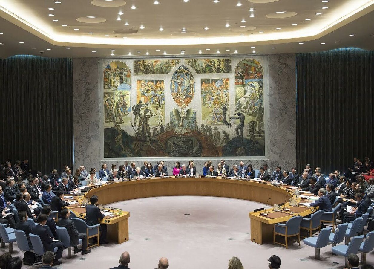 United Nations Security Council session, used to frame geopolitics as institutional and executive rather than theatrical